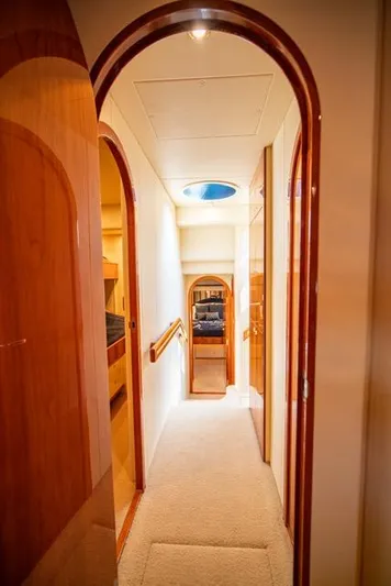 Yacht Photos Pics Interior hallway of 2005 Neptunus 62 Flybridge yacht with wooden accents.