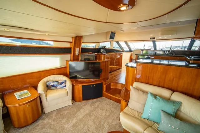  Yacht Photos Pics Luxurious interior of 2005 Neptunus 62 Flybridge yacht with plush seating and modern amenities.