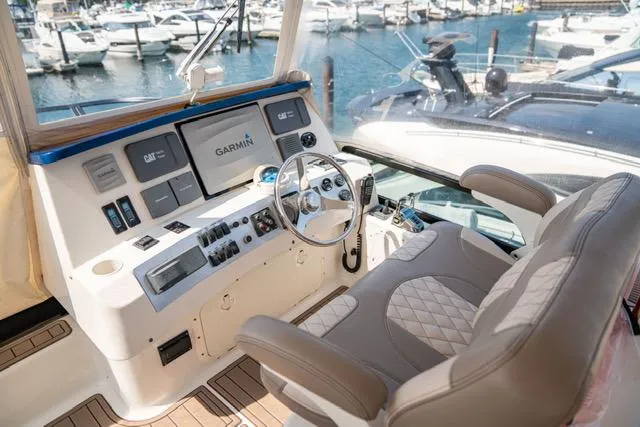  Yacht Photos Pics 2005 Neptunus 62 Flybridge helm with Garmin navigation, overlooking marina.