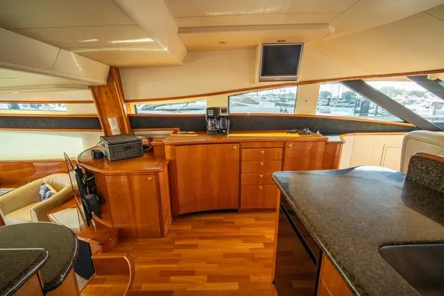 Yacht Photos Pics Luxurious 2005 Neptunus 62 Flybridge yacht interior with wood cabinetry and modern amenities.