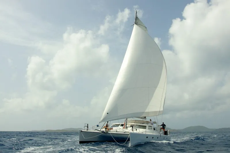 Osprey Yacht Photos Pics Sailing Voyage Yachts 520 catamaran, 2011 model, on open sea under cloudy sky.