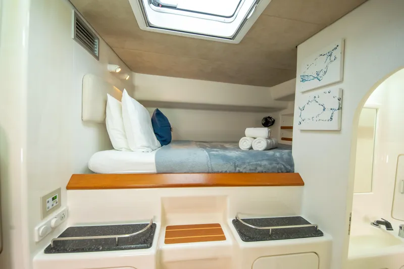 Osprey Yacht Photos Pics Luxurious cabin interior of 2011 Voyage Yachts 520, featuring cozy bedding and modern amenities.