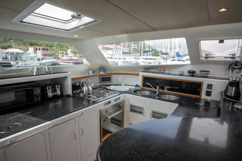 Osprey Yacht Photos Pics Modern kitchen interior of 2011 Voyage Yachts 520, featuring sleek countertops and appliances.