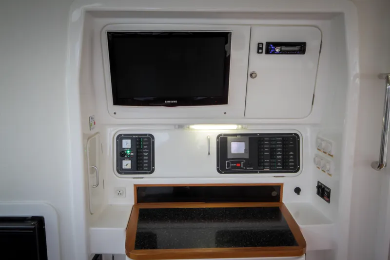 Osprey Yacht Photos Pics Control panel and TV setup on 2011 Voyage Yachts 520, featuring modern navigation equipment.