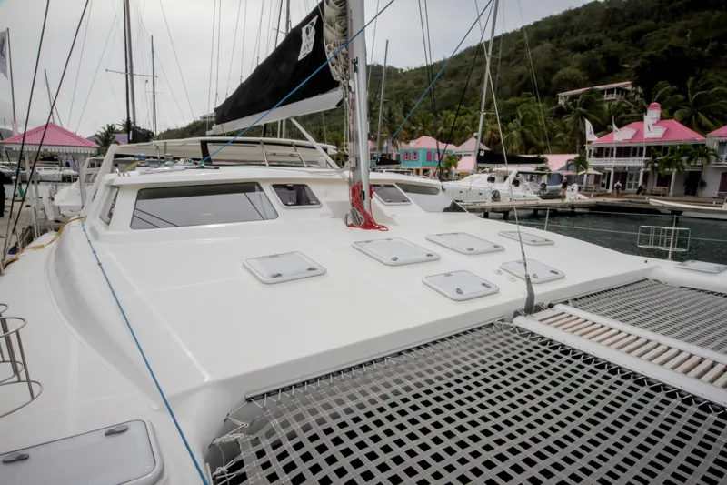 Osprey Yacht Photos Pics 2011 Voyage Yachts 520 catamaran docked at a vibrant marina with colorful buildings.