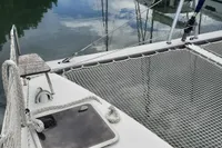 Nautitech 40 Open catamaran deck with netting, reflecting calm water, 2014 model.