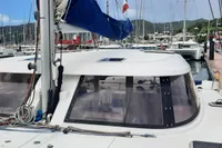 Nautitech 40 Open catamaran, 2014 model, docked at a marina with surrounding sailboats.