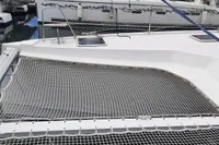 Nautitech 40 Open 2014 catamaran deck with netting, docked at marina.