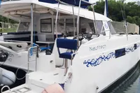 2014 Nautitech 40 Open catamaran docked, featuring elegant design and spacious deck area.