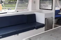 Interior of 2014 Nautitech 40 Open yacht with blue seating and dining area.