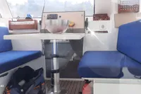 Interior of 2014 Nautitech 40 Open catamaran with blue seating and a central table.