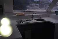 Interior of 2014 Nautitech 40 Open yacht kitchen with stove and sink.