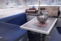 Interior of 2014 Nautitech 40 Open yacht with blue seating and dining table.