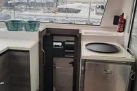Interior of 2014 Nautitech 40 Open yacht kitchen with modern appliances and window view.