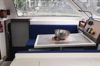 Interior of 2014 Nautitech 40 Open catamaran with dining area and table setting.