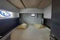 Cabin interior of 2014 Nautitech 40 Open yacht with two pillows and a small window.
