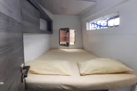 Cozy cabin interior of 2014 Nautitech 40 Open yacht with bed and window.