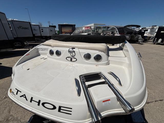 2014 Tracker Tahoe Q5 boat with swim platform and ladder, parked outdoors.