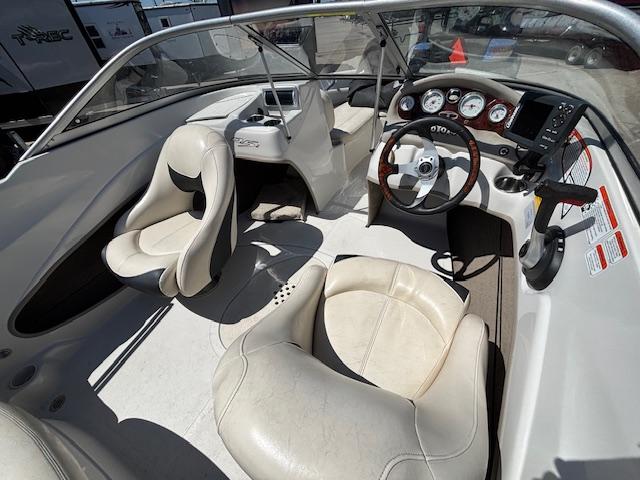 2014 Tracker Tahoe Q5 boat interior with steering wheel and white seating.