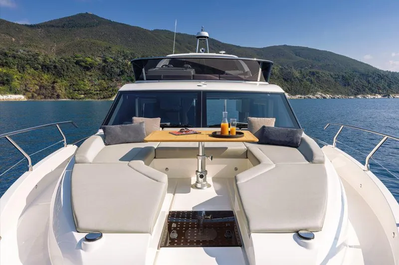 Absolute 47 Fly Yacht Photos Pics 2025 Absolute 47 Fly yacht with elegant seating, table, and scenic ocean view.