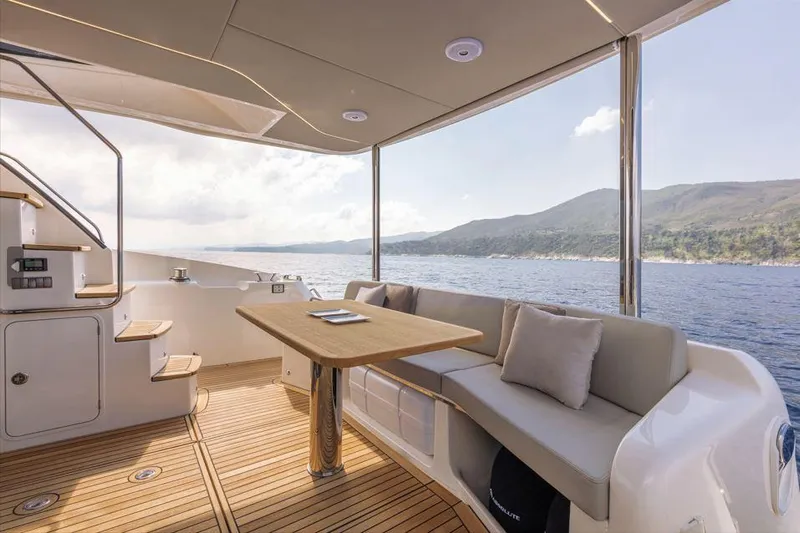 Absolute 47 Fly Yacht Photos Pics Luxurious Absolute 47 Fly yacht interior with ocean view, featuring elegant seating and wooden flooring.