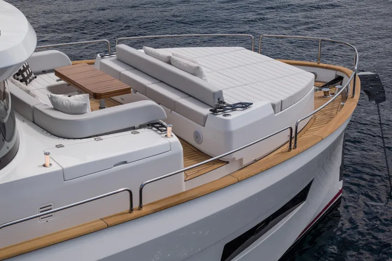  Yacht Photos Pics Luxurious Sirena 60 yacht deck, 2026 model, featuring elegant seating and a wooden table.