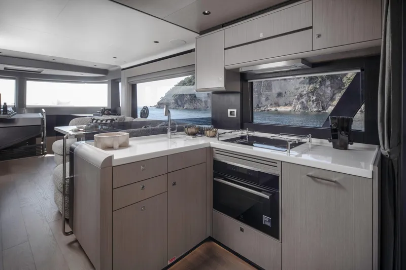  Yacht Photos Pics Modern kitchen interior on 2026 Sirena 60 yacht with ocean view through large windows.