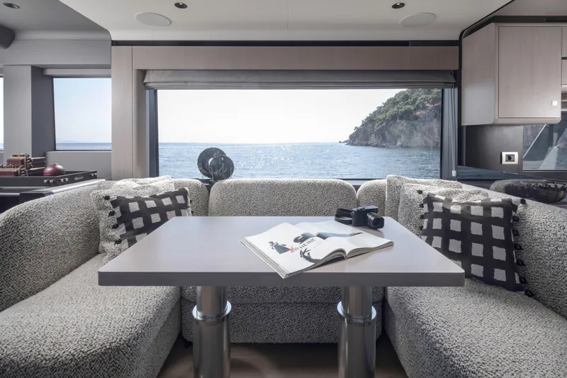  Yacht Photos Pics Luxurious interior of 2026 Sirena 60 yacht with ocean view, cozy seating, and modern decor.