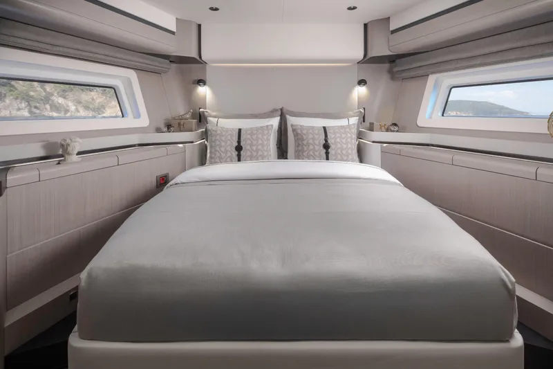  Yacht Photos Pics Luxurious bedroom interior of 2026 Sirena 60 yacht with modern design and large windows.