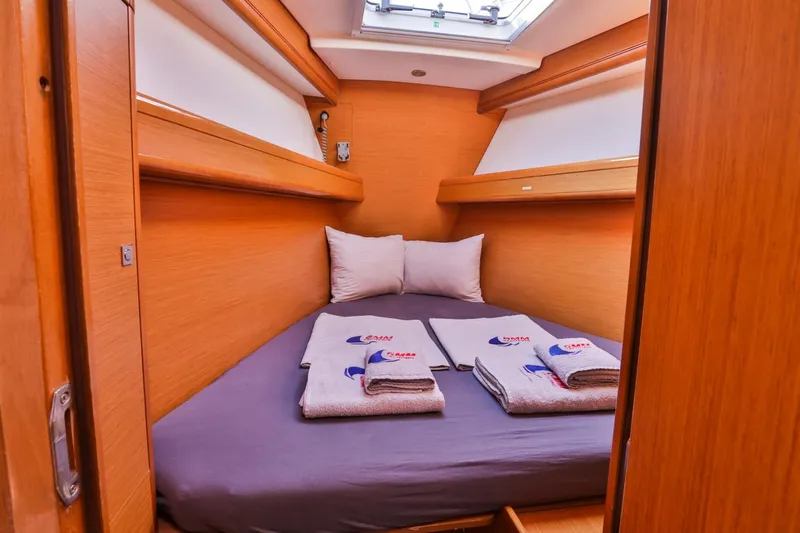 Amelie Yacht Photos Pics Cozy cabin interior of 2011 Jeanneau 57 yacht with neatly arranged bedding.