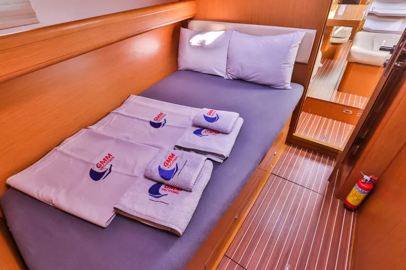 Amelie Yacht Photos Pics Cozy cabin interior of 2011 Jeanneau 57 yacht with neatly arranged towels.