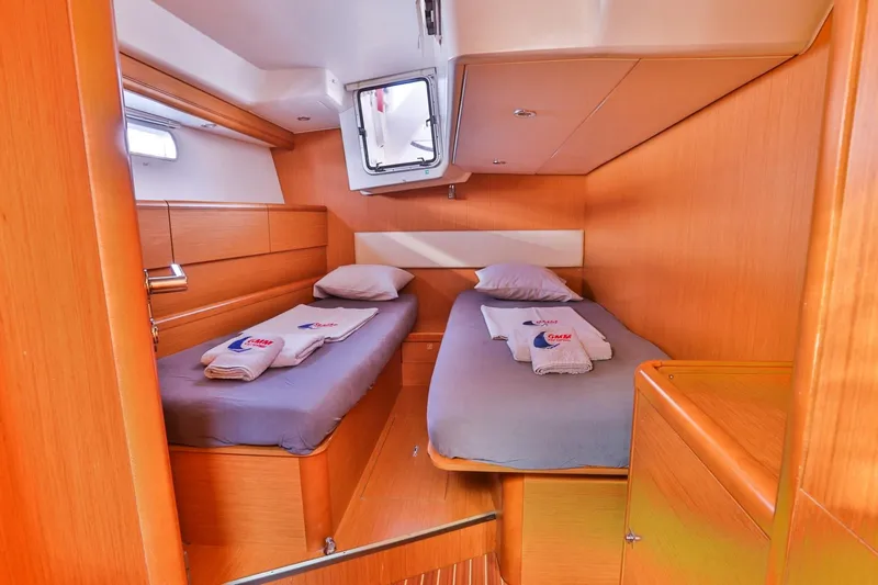 Amelie Yacht Photos Pics Twin cabin interior of 2011 Jeanneau 57 yacht with cozy bedding.