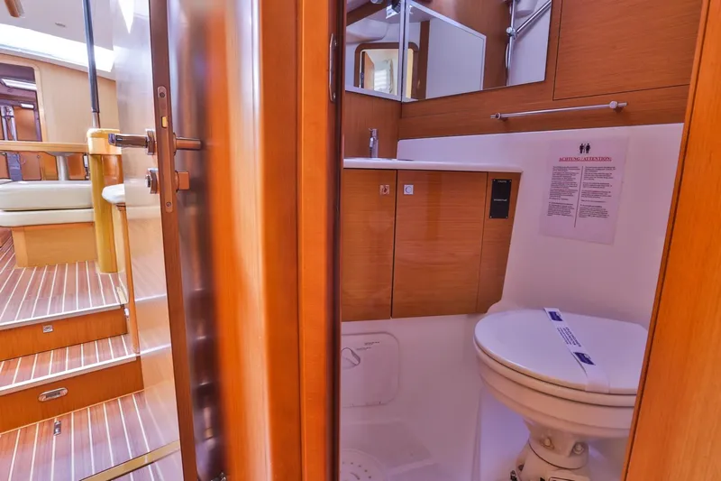 Amelie Yacht Photos Pics Interior of 2011 Jeanneau 57 yacht bathroom with wooden finish and modern amenities.