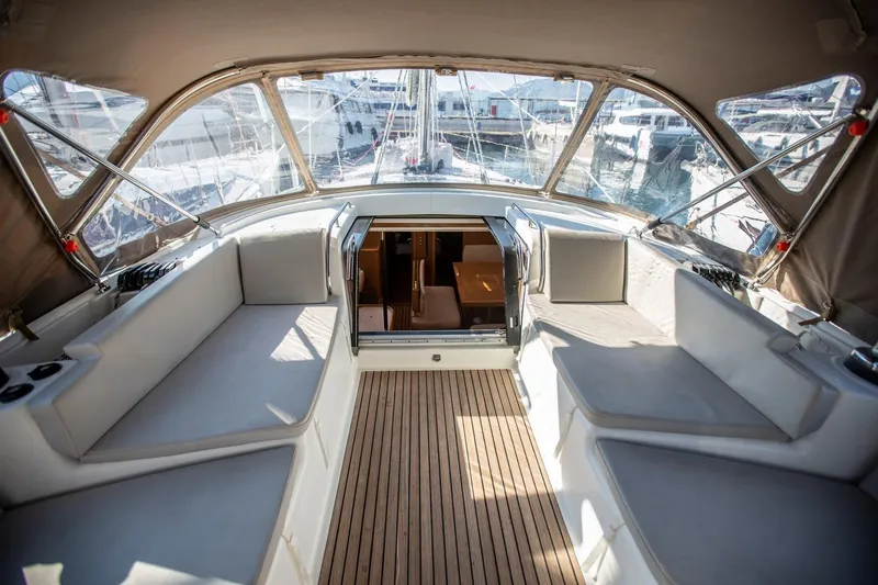 Amelie Yacht Photos Pics Luxurious 2011 Jeanneau 57 yacht interior with spacious seating and elegant wood flooring.