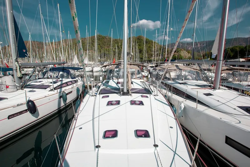 Amelie Yacht Photos Pics Jeanneau 57 sailboats docked in a marina, 2011 model, surrounded by masts and clear skies.