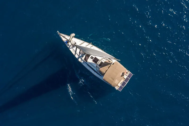 Amelie Yacht Photos Pics Aerial view of 2011 Jeanneau 57 yacht sailing on deep blue ocean.