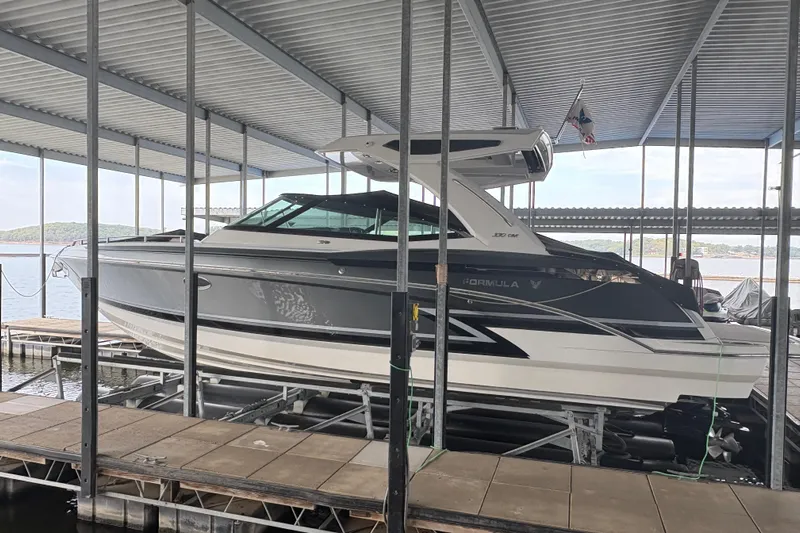  Yacht Photos Pics 2021 Formula 330 Crossover Bowrider I/O docked under a covered marina.