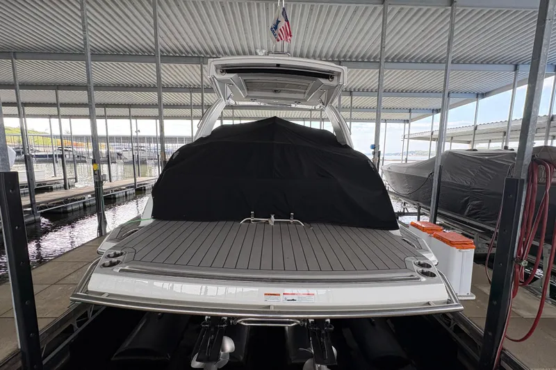  Yacht Photos Pics 2021 Formula 330 Crossover Bowrider I/O docked under a covered marina.