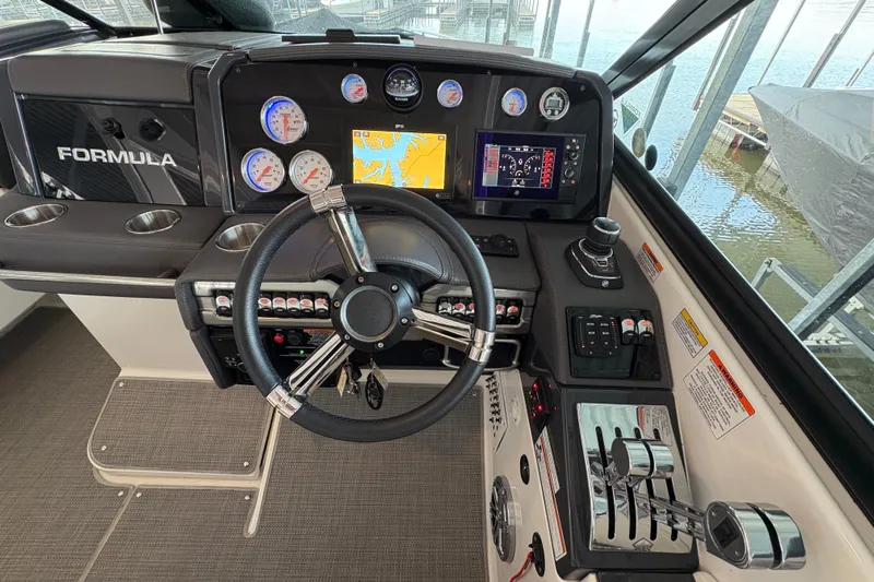  Yacht Photos Pics 2021 Formula 330 Crossover Bowrider I/O dashboard with steering wheel and navigation controls.