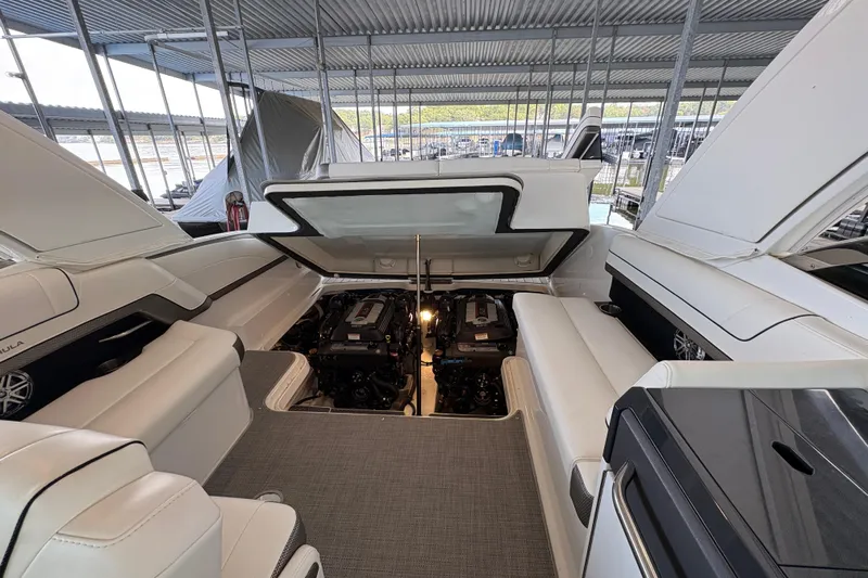  Yacht Photos Pics 2021 Formula 330 Crossover Bowrider I/O with open engine compartment in marina setting.