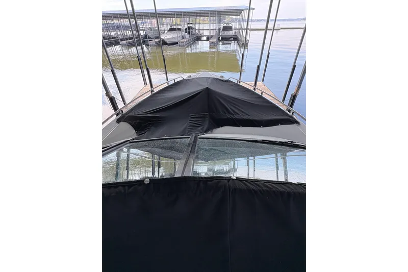  Yacht Photos Pics 2021 Formula 330 Crossover Bowrider I/O docked, covered with black canvas.