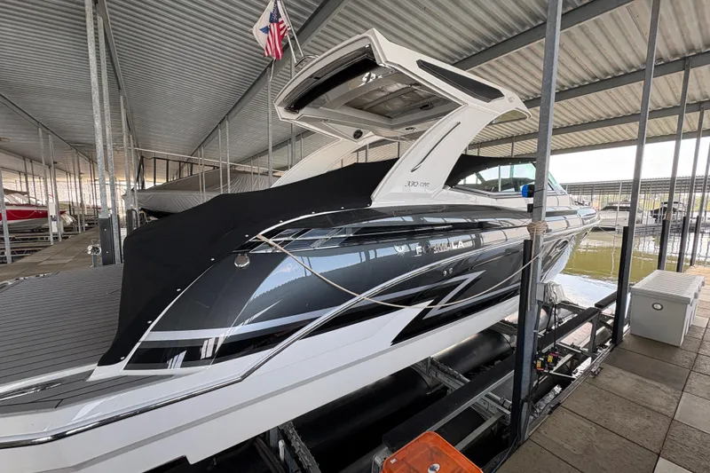  Yacht Photos Pics 2021 Formula 330 Crossover Bowrider I/O docked under a covered marina.