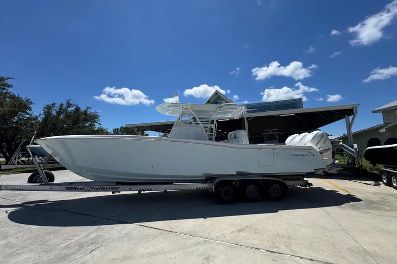  Yacht Photos Pics 2021 Invincible 36 Open Fisherman boat on trailer under clear blue sky.