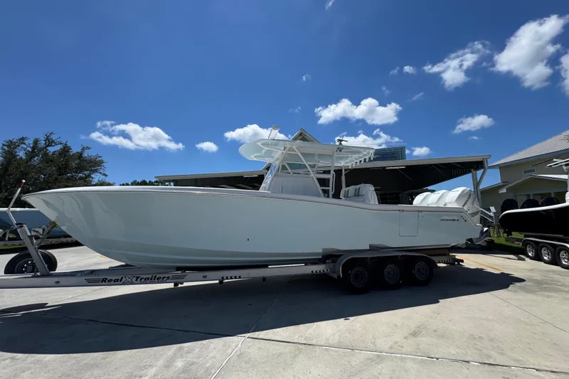  Yacht Photos Pics 2021 Invincible 36 Open Fisherman boat on trailer under clear blue sky.