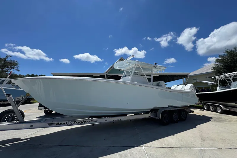  Yacht Photos Pics 2021 Invincible 36 Open Fisherman boat on trailer under clear blue sky.