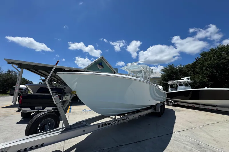  Yacht Photos Pics 2021 Invincible 36 Open Fisherman boat on trailer under clear blue sky.