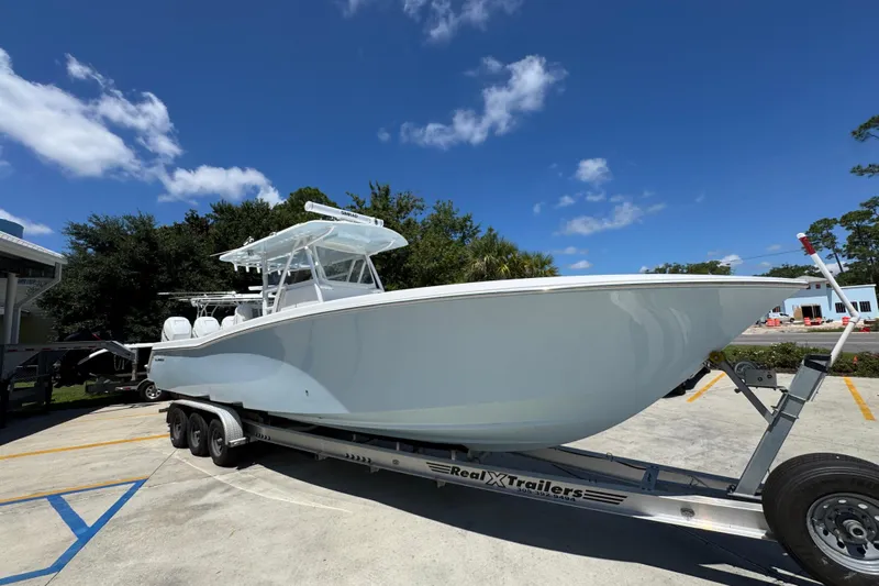  Yacht Photos Pics 2021 Invincible 36 Open Fisherman boat on trailer under clear blue sky.