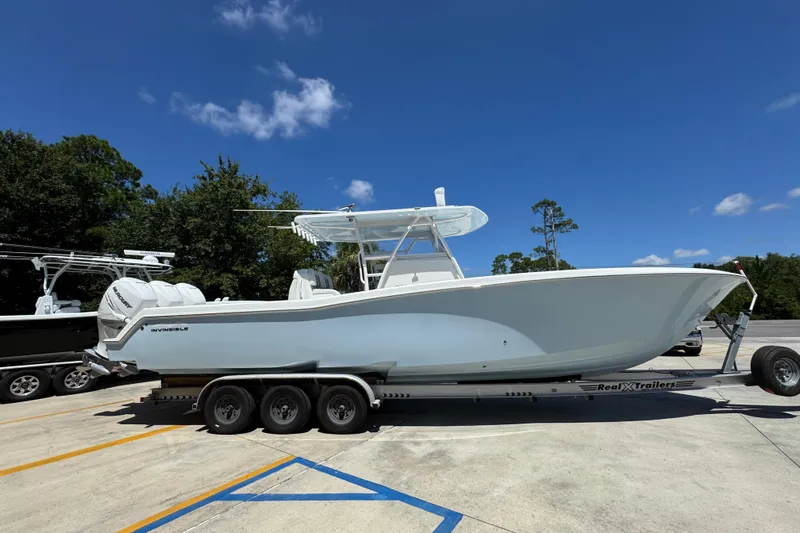  Yacht Photos Pics 2021 Invincible 36 Open Fisherman boat on trailer under clear blue sky.