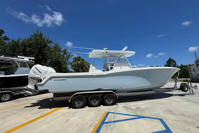  Yacht Photos Pics 2021 Invincible 36 Open Fisherman boat on trailer under clear blue sky.