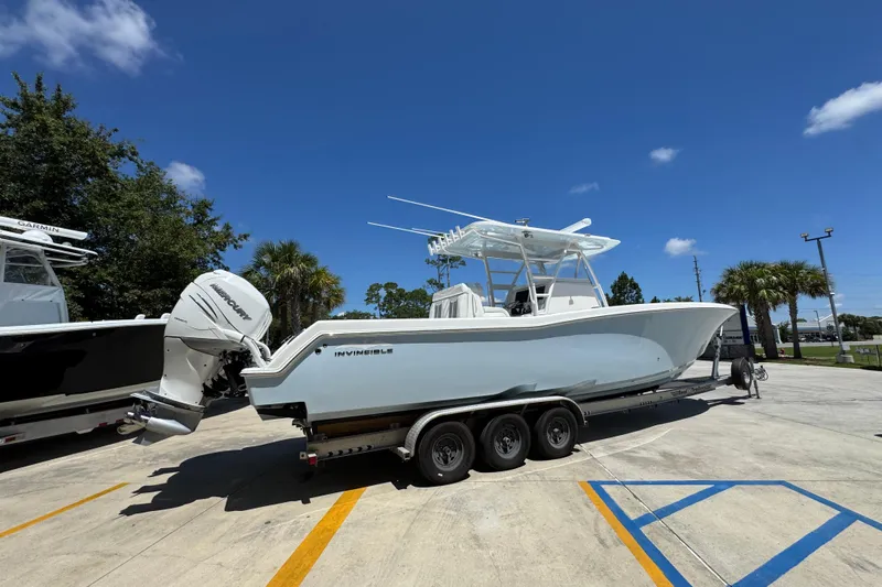  Yacht Photos Pics 2021 Invincible 36 Open Fisherman boat on trailer under clear blue sky.